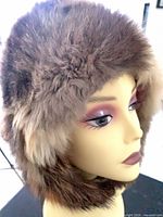 Right side view of multitone brown fur hat on mannequin