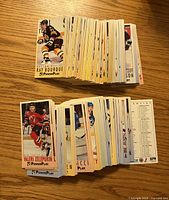 Two stacks of 1993-94 Fleer Power Play hockey cards displayed front card showing Ray Bourque, another showing Valeri Zelepukin, checklist visible