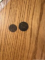 Obverse view of two coins showing Britannia and date