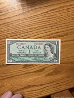 Obverse of 1954 Canadian $1 bill showing serial number, portrait, denomination