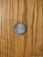 Reverse showing CANADA 1958 DOLLAR with totem pole design