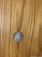 Reverse side showing Canadian coat of arms and 1962 date