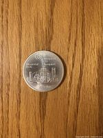 Reverse side of 1976 Montreal Olympics $10 silver coin displaying skyline and Olympic logo