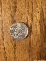 Reverse showing Olympic emblem, laurel wreath and inscriptions