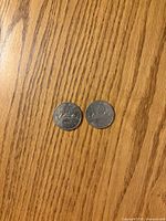 1978 and 1979 Canadian Voyageur dollars reverse side on wood surface