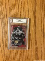 Front of Ed Belfour Ultimate Memorabilia stick card showing player image and stick piece