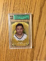 Front of encased Ed Belfour gold card showing player image, gold foil background, serial number 02/09 on label
