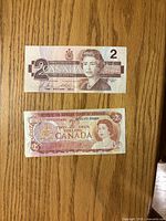 Obverse of both $2 notes showing Queen Elizabeth II portraits and denomination