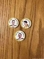 Front view of three Bruins hockey coins showing player portraits