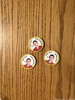 Front views of three NHL Chicago Blackhawks plastic coins showing player portraits and names