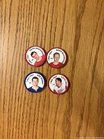 Front view of four NHL player coins showing portraits and team colors