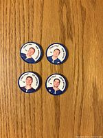 Front view of four Rangers coins showing player portraits