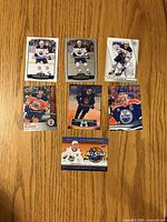 All seven Connor McDavid hockey cards laid out on table
