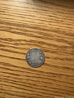 Reverse view showing crown, denomination, wreath, date