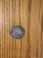 Reverse of 1965 Canadian silver dollar – Voyageur design visible