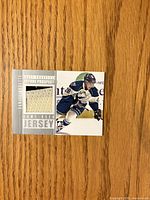 Front of card showing player image, jersey swatch and text