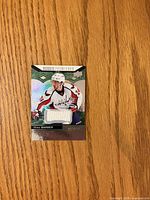 Front of Riley Barber Rookie Premieres jersey card showing player image, jersey swatch, serial number 125/399