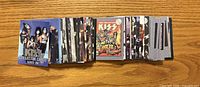 Front view of stacked KISS Series 1 cards showing various fronts including band photo and comic art