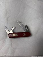 Victorinox red Swiss Army multi-tool open showing four implements