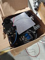 Open cardboard box filled with Ender 3D printer components