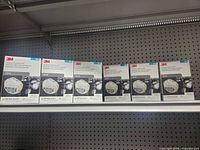 Six sealed 20-count boxes of 3M 8210 N95 masks on shelf