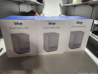 Front view of three sealed Blue by ADT smart home hub boxes
