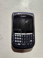 Front view showing keypad, screen, branding and damage above display