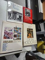 Four books laid out: The Jewish Quarter of Philadelphia, Milton Steinberg Portrait of a Rabbi, Jerusalem Through the Eyes of 20 Israeli Painters, Art of the Holocaust