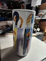 Side view showing umbrella graphics on ceramic cylinder