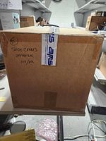 Closed case showing handwritten label and tape