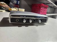 Front view showing model branding, control knobs and headphone jack