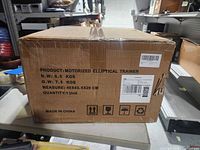 Front of sealed box showing product name, weights, dimensions, origin