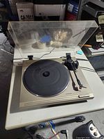 Top view of Pioneer turntable with dust cover open on table