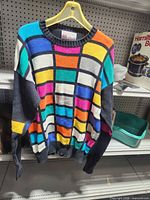 Front view of multicolour Slazenger sweater on hanger
