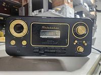 Front view showing cassette deck, control buttons and knobs