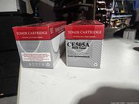 Front view of two CE505A MICR toner cartridge boxes