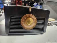 Front view showing dial, grill, and Bakelite case