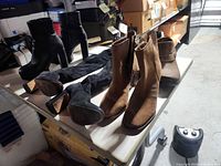 All four pairs of boots on table