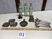 Group shot of all 13 items with scale ruler