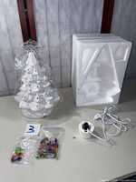 Full lot showing ceramic tree, bulb cap bags, lamp base and styrofoam insert