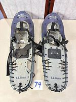 Pair of L.L.Bean Pathfinder 26 snowshoes top view showing bindings and deck