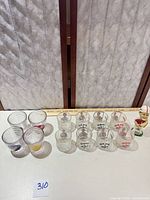 Full lot view showing 12 glasses and bobblehead