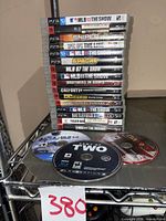 Stack of 16 PS3 games in cases plus three loose discs on shelf