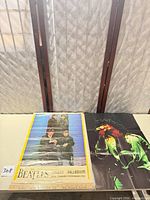 Both posters side by side on table