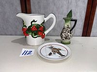 Group overview of pitcher, decanter with stopper, and collector plate