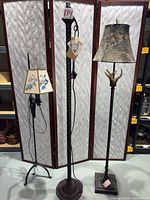 Three floor lamps standing side by side showing overall view