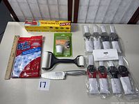 Overview of all items laid out including knife, roller, wipes, cling wrap, descaling kit, and eight wrapped shears