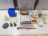 Full lot overview showing candles, holders, candlesticks, snuffer, basket