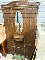 Full front view showing entire hall tree, mirror, hooks, rails, glove box, drip tray