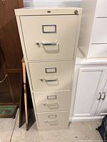 Front view of beige HON 4-drawer steel filing cabinet